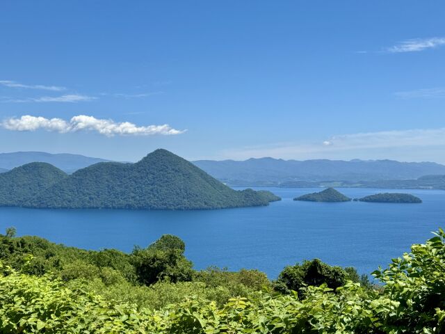 Lake Toya seen from the rim above, the forested Nakajima lava domes standing in the middle of the caldera lake